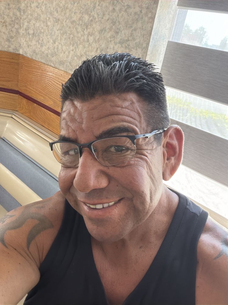 A customer showing a fresh, sharp haircut from Ray's Barber Shop
