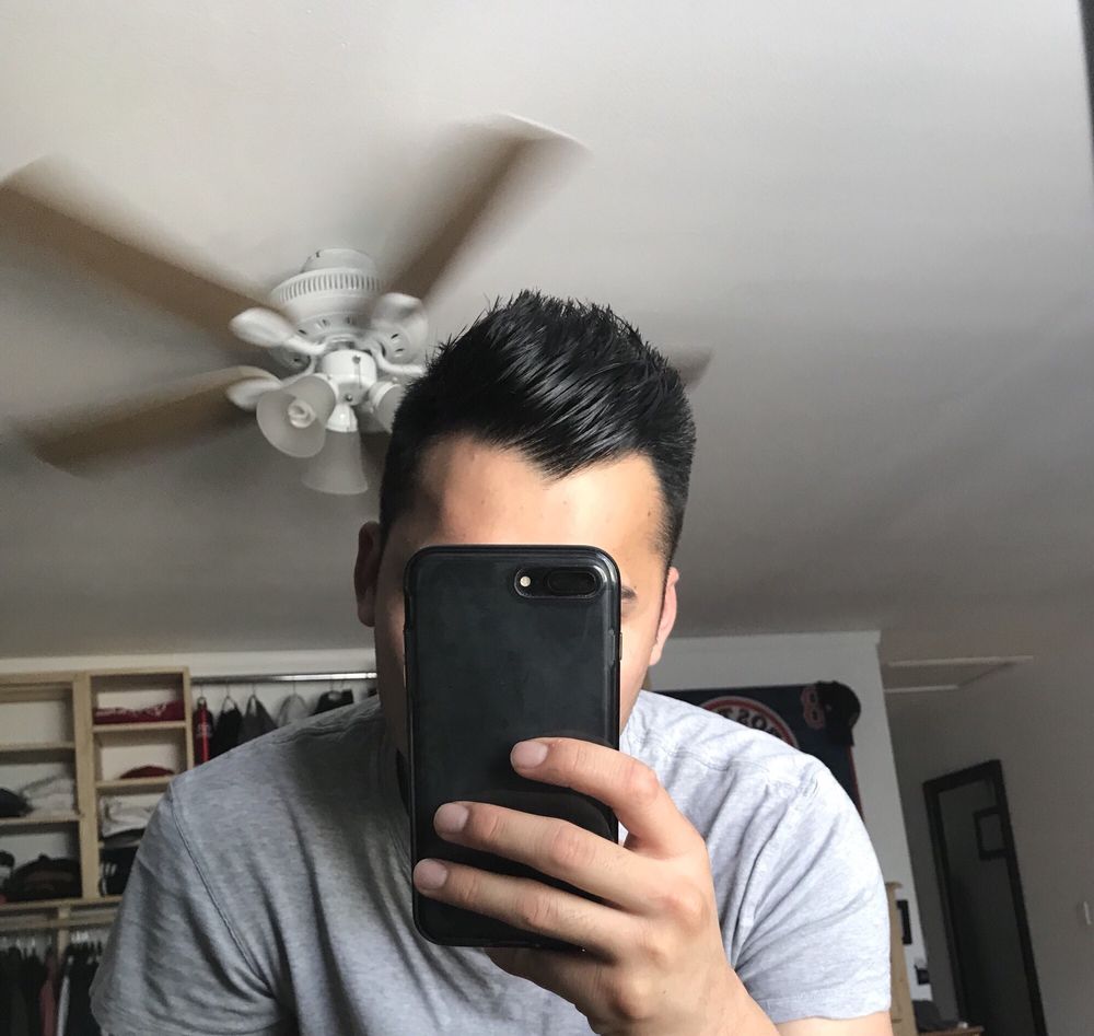 A customer showing a clean styled haircut from Ray's Barber Shop